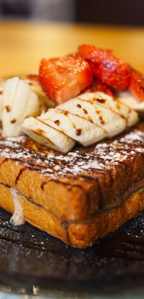 Sweeten your day! 🍓 Dive into our delectable French toast, topped with fresh bananas and strawb